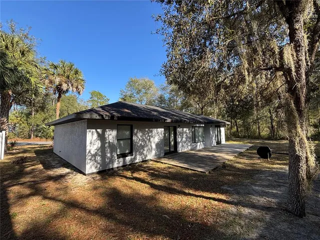 a view of a yard with large trees