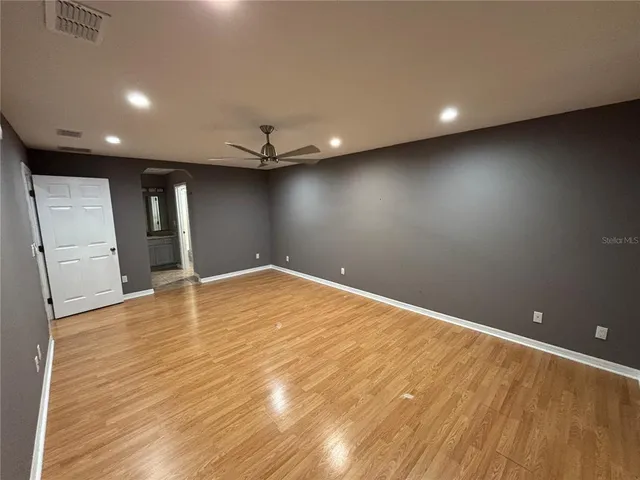 an empty room with wooden floor