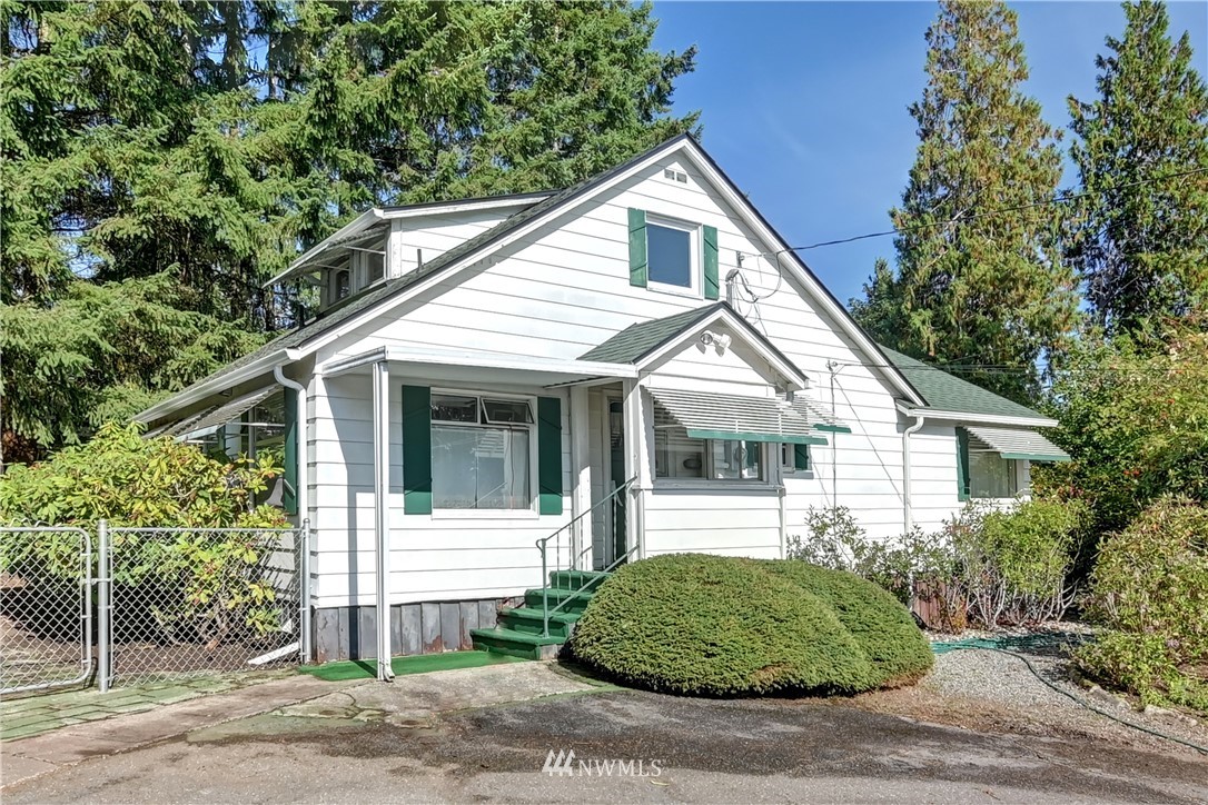 19722 13th Drive Southeast Bothell, WA 98012 - Photo 2 of 21 a view of small white house with a small garden