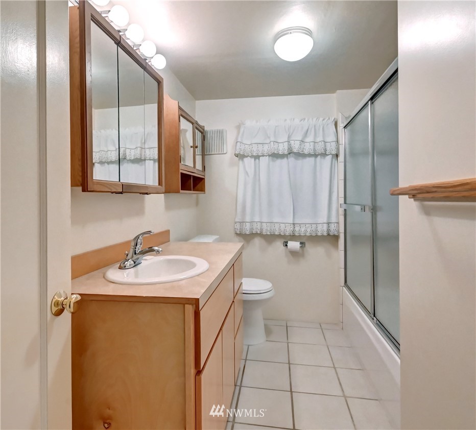 19722 13th Drive Southeast Bothell, WA 98012 - Photo 16 of 21 a bathroom with a sink toilet and shower