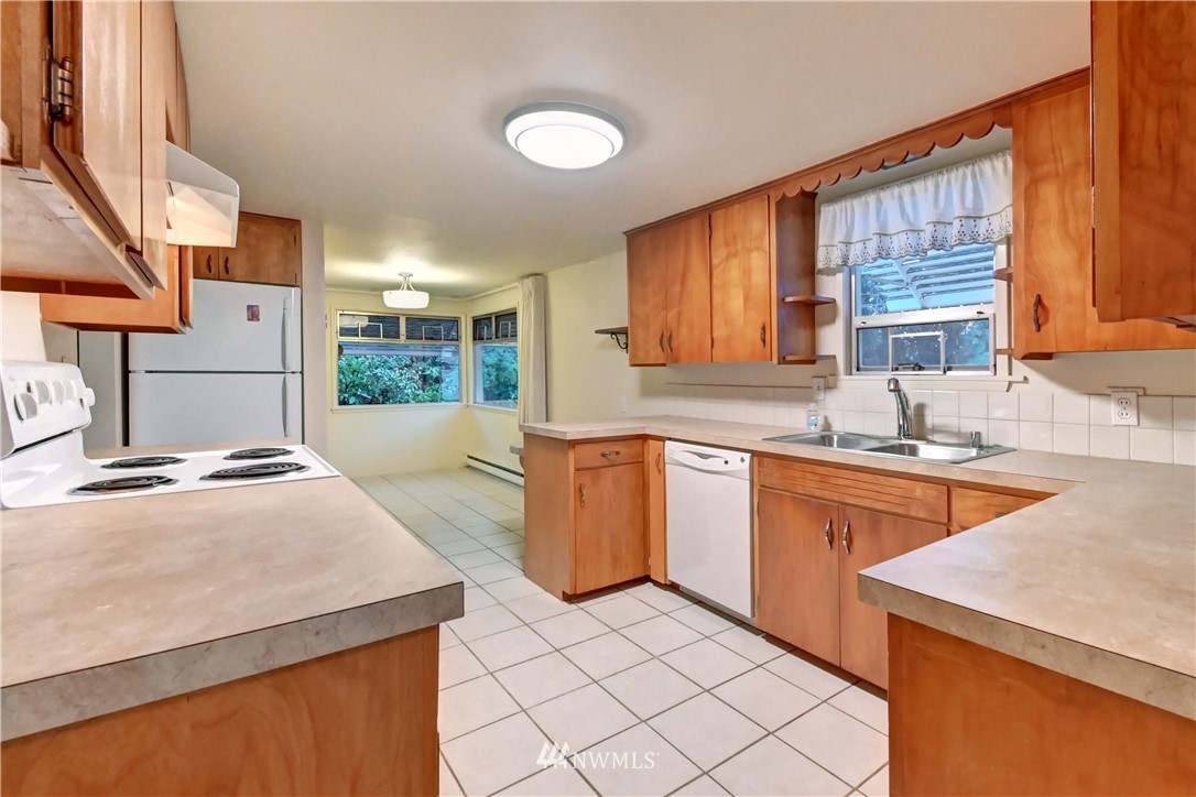 19722 13th Drive Southeast Bothell, WA 98012 - Photo 6 of 21 a kitchen with a sink stove and cabinets