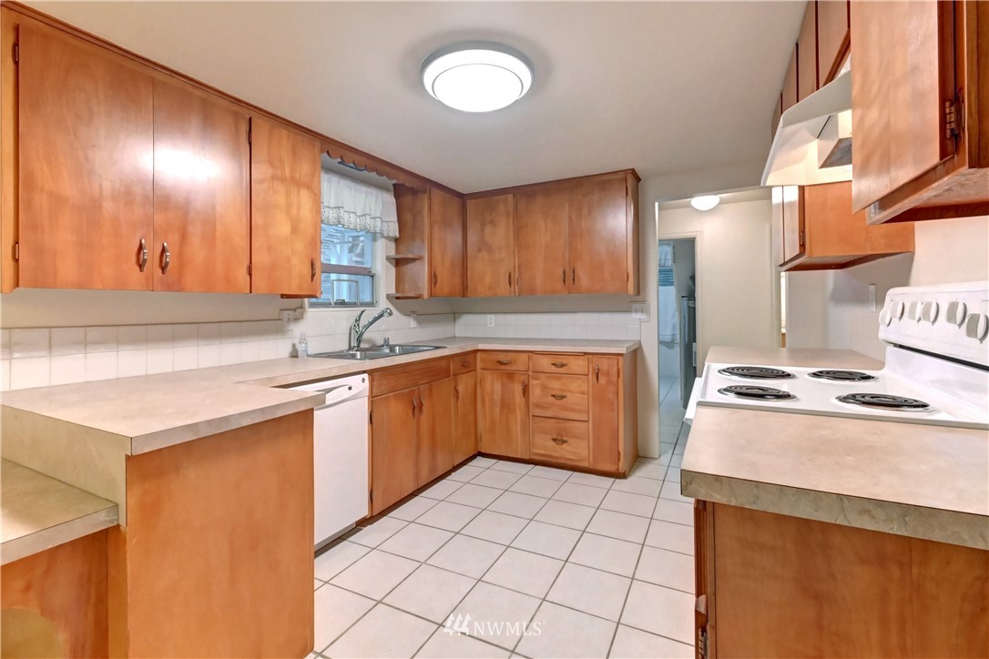 19722 13th Drive Southeast Bothell, WA 98012 - Photo 7 of 21 a kitchen with stainless steel appliances granite countertop a stove a sink and a refrigerator