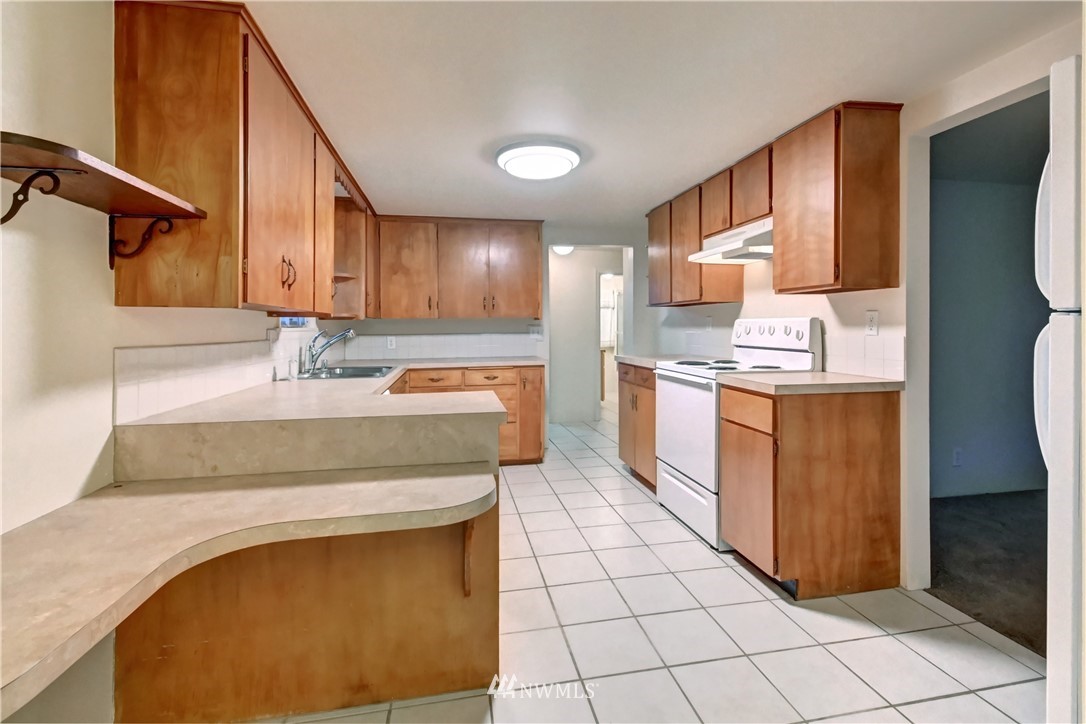 19722 13th Drive Southeast Bothell, WA 98012 - Photo 8 of 21 a kitchen with stainless steel appliances granite countertop a sink stove and cabinets