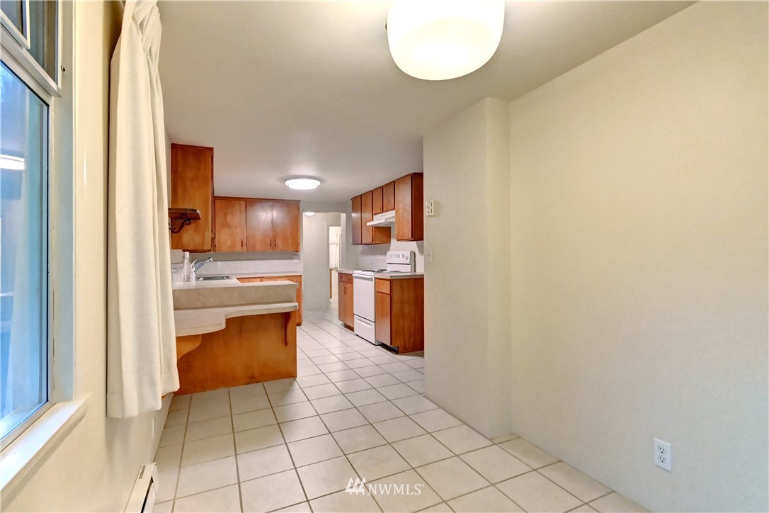 19722 13th Drive Southeast Bothell, WA 98012 - Photo 9 of 21 a kitchen with stainless steel appliances a refrigerator and a stove top oven