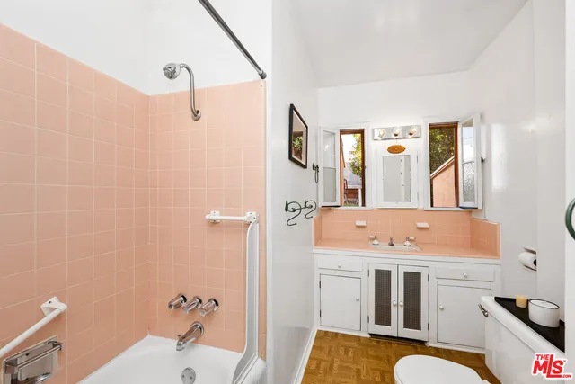 a bathroom with a sink a tub and a mirror