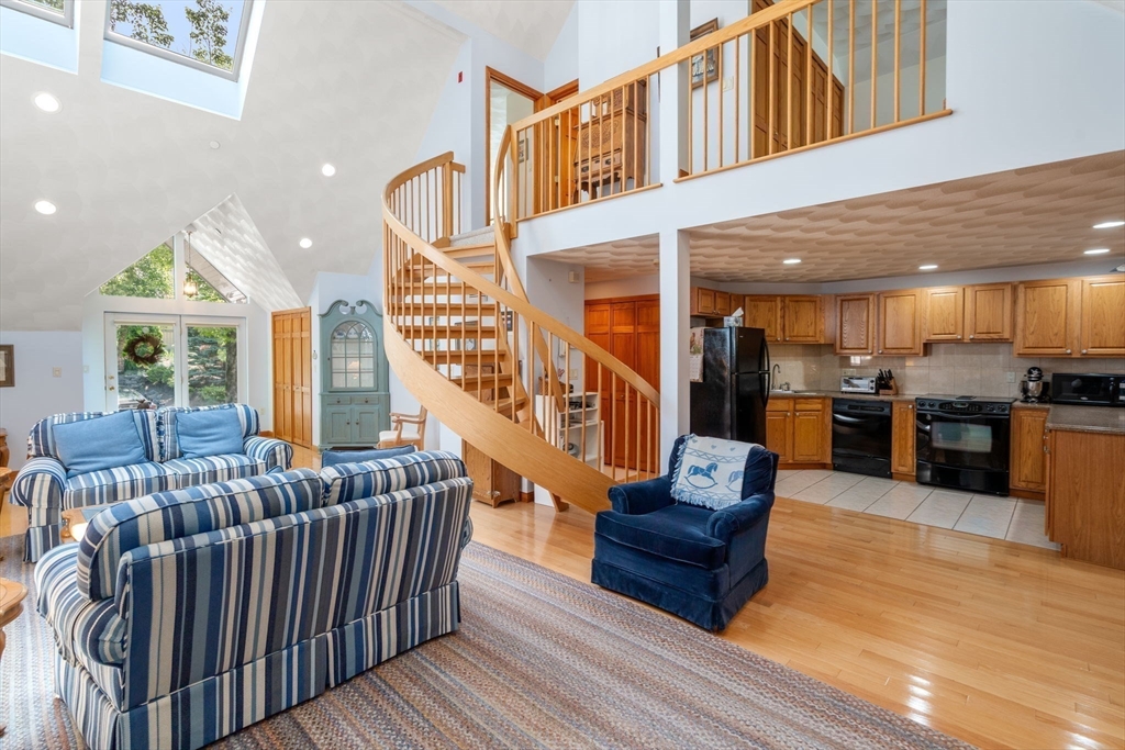 46 Deer Path, Unit 46 Hudson, MA 01749 - Photo 8 of 23 a living room with furniture or kitchen view and a wooden floor