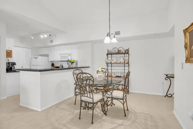 a view of a dining room with furniture and a chandelier