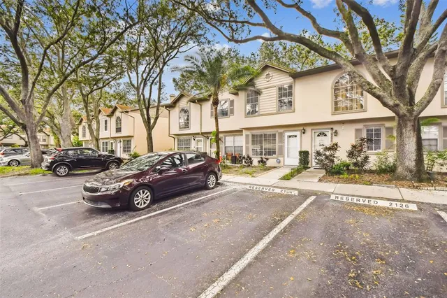 a view of a house with swimming pool and a table and chairs