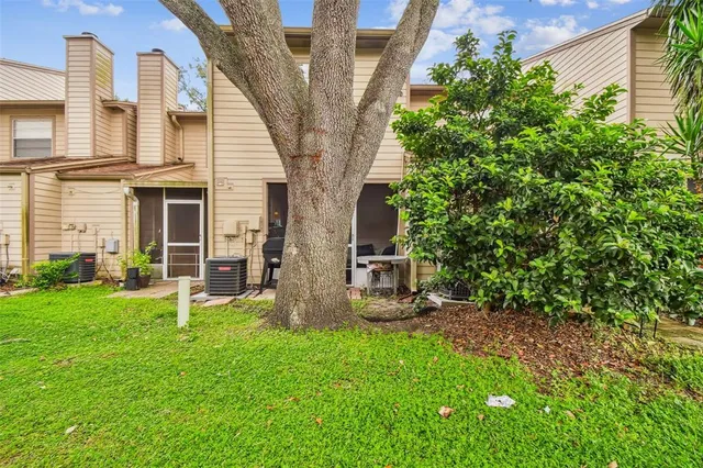 an aerial view of lake residential house with swimming pool and green space