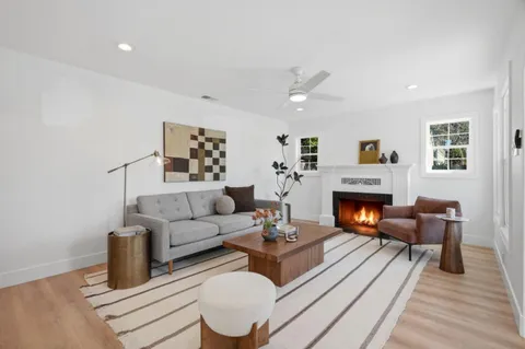 a living room with furniture fireplace and window