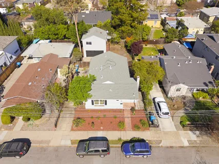 an aerial view of residential houses with outdoor space