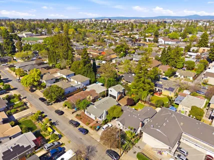 an aerial view of residential houses with outdoor space
