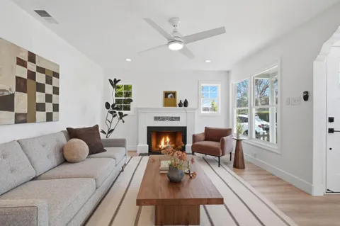 a living room with furniture fireplace and window