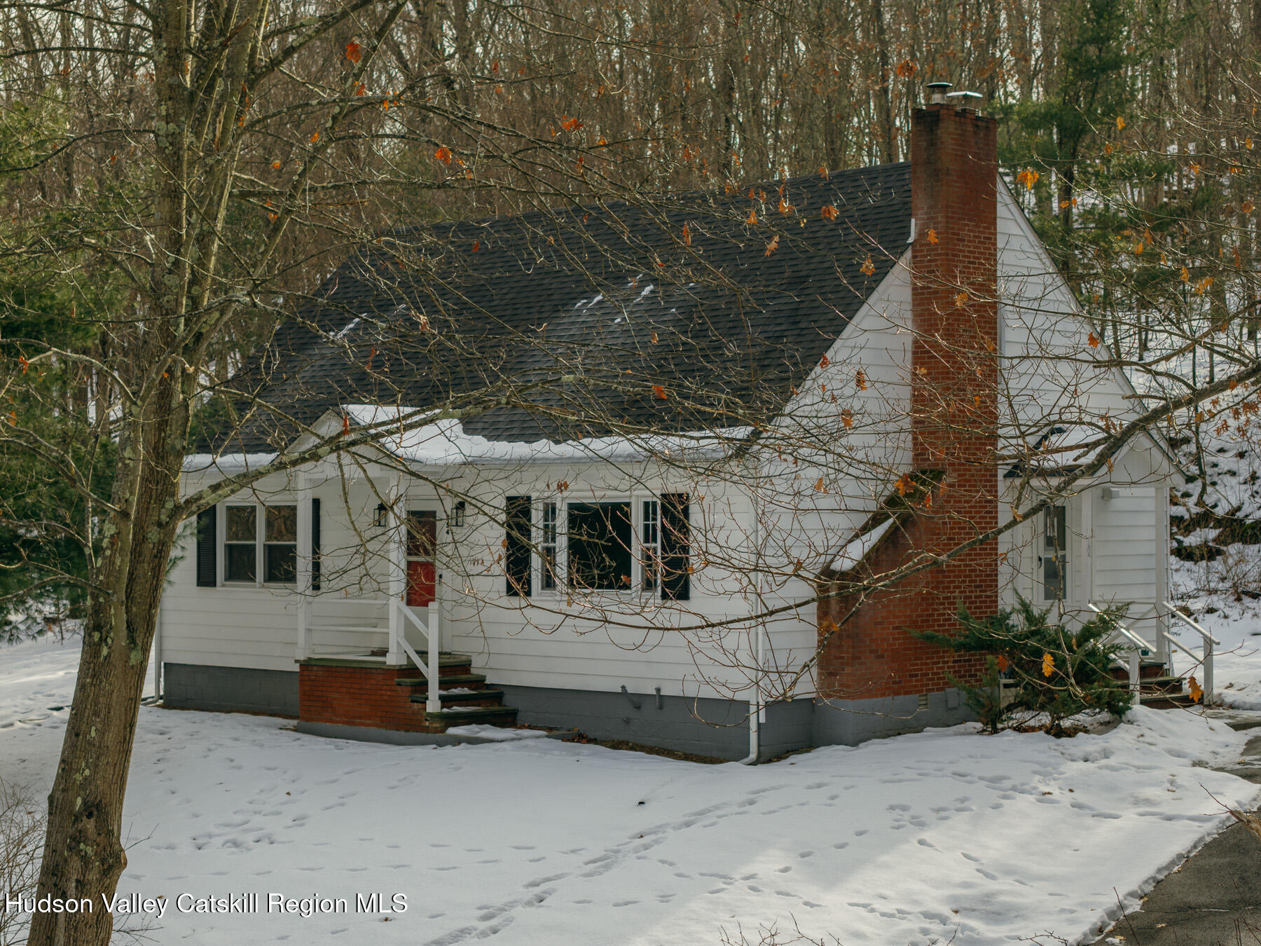 354 Slate Quarry Road Rhinebeck, NY 12572 - Photo 1 of 33 front view of a house with a bench