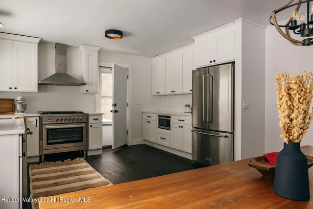 a kitchen with a refrigerator stove and wooden cabinets