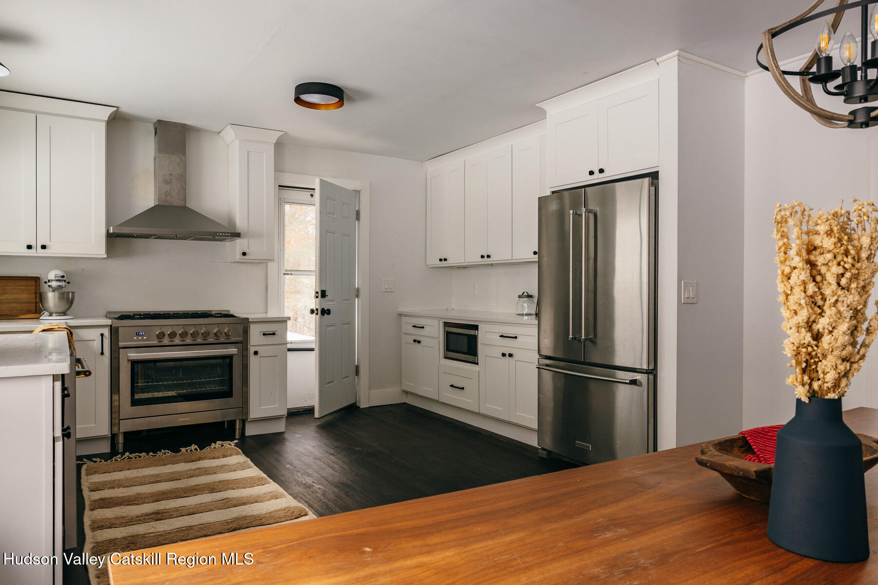 354 Slate Quarry Road Rhinebeck, NY 12572 - Photo 12 of 33 a kitchen with a refrigerator stove and wooden cabinets