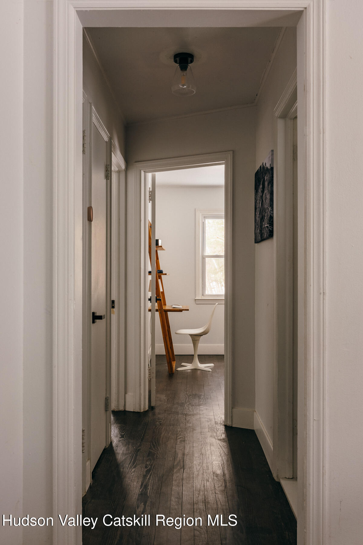 354 Slate Quarry Road Rhinebeck, NY 12572 - Photo 14 of 33 a view of a hallway with wooden floor and a living room