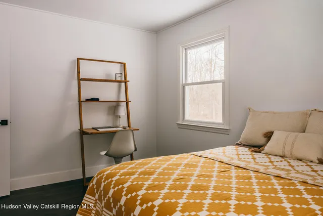 a bedroom with a bed and a window