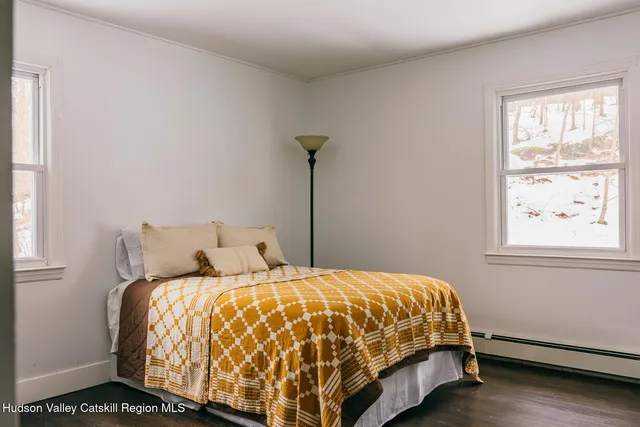 a bed sitting in a bedroom next to a window
