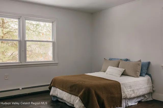 a bedroom with a bed and window