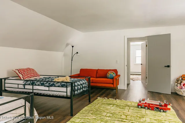 a living room with furniture rug and lamp