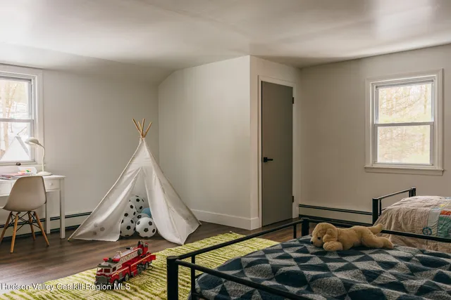 a room with lots of furniture and wooden floor