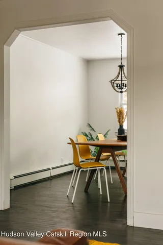 a dining room with furniture and wooden floor