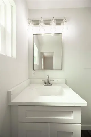 a view of a room with wooden floor and a ceiling fan