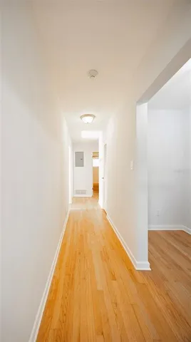 a view of a room with wooden floor and a ceiling fan