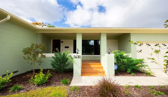 a view of a house with potted plants