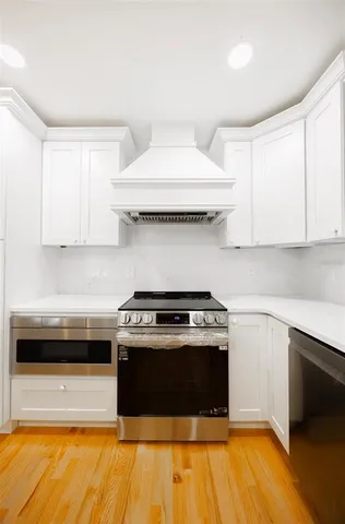 a view of a kitchen with wooden floor and a sink