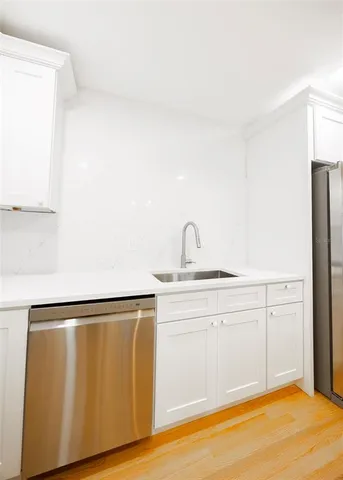 a kitchen with a stove a refrigerator and a sink