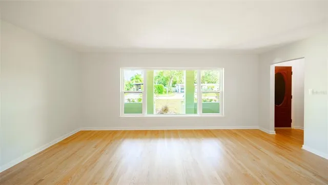 a swimming pool with a large window and wooden floor
