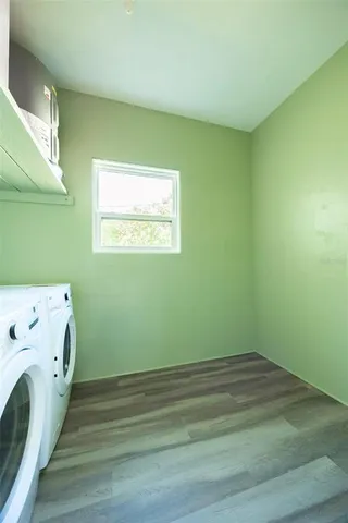 a view of a patio with table and chairs potted plants with wooden floor and fence