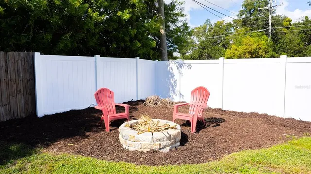 a view of a house with a yard and sitting area