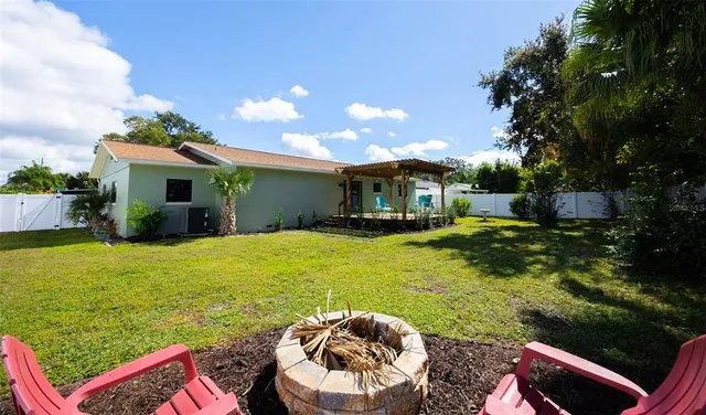 a view of a house with backyard sitting area and garden