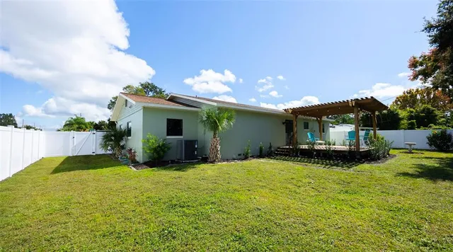a view of a house with swimming pool and sitting area