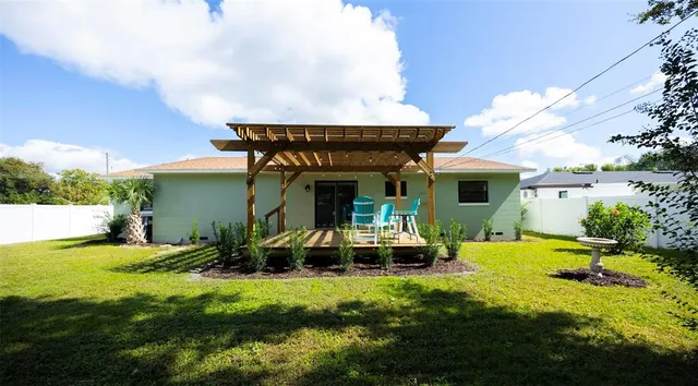 a view of a house with swimming pool and sitting area