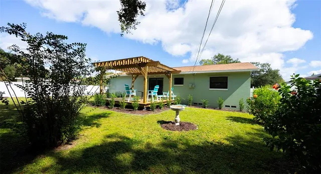a view of a patio with table and chairs potted plants with wooden floor and fence