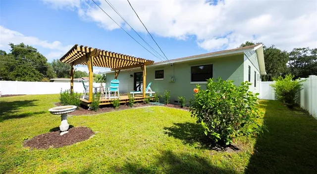 a view of a swimming pool with a patio and a yard