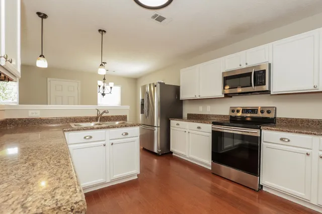 a kitchen with a sink stove and microwave