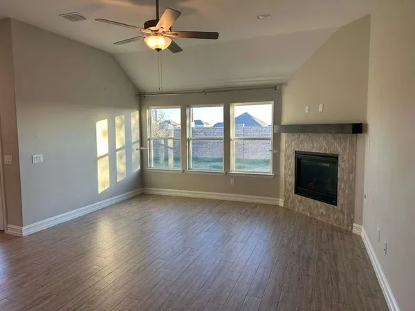 wooden floor in an empty room with a fireplace