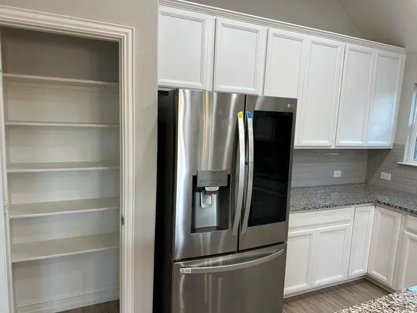 a kitchen with a stove a sink and a microwave