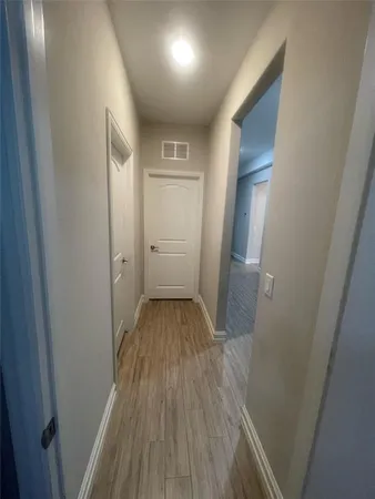 a view of hallway with wooden floor