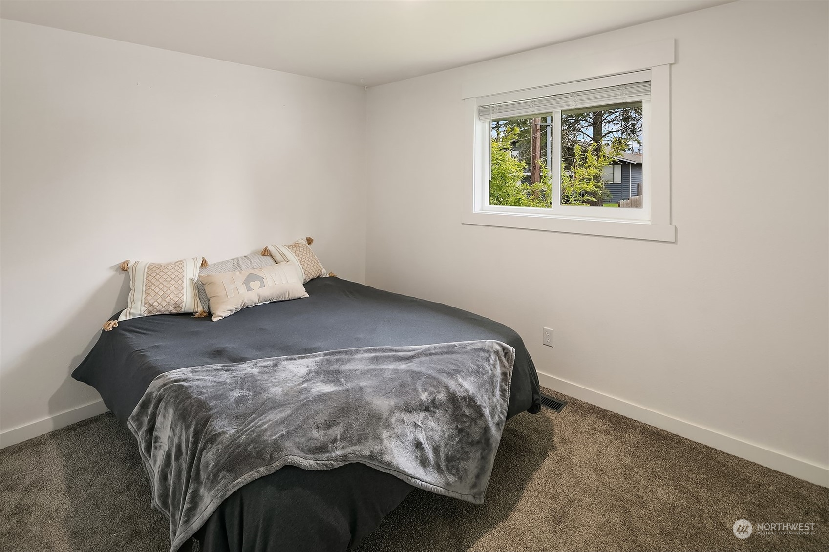 4419 Southeast 4th Place Renton, WA 98059 - Photo 12 of 21 a bed sitting in a bedroom next to a window