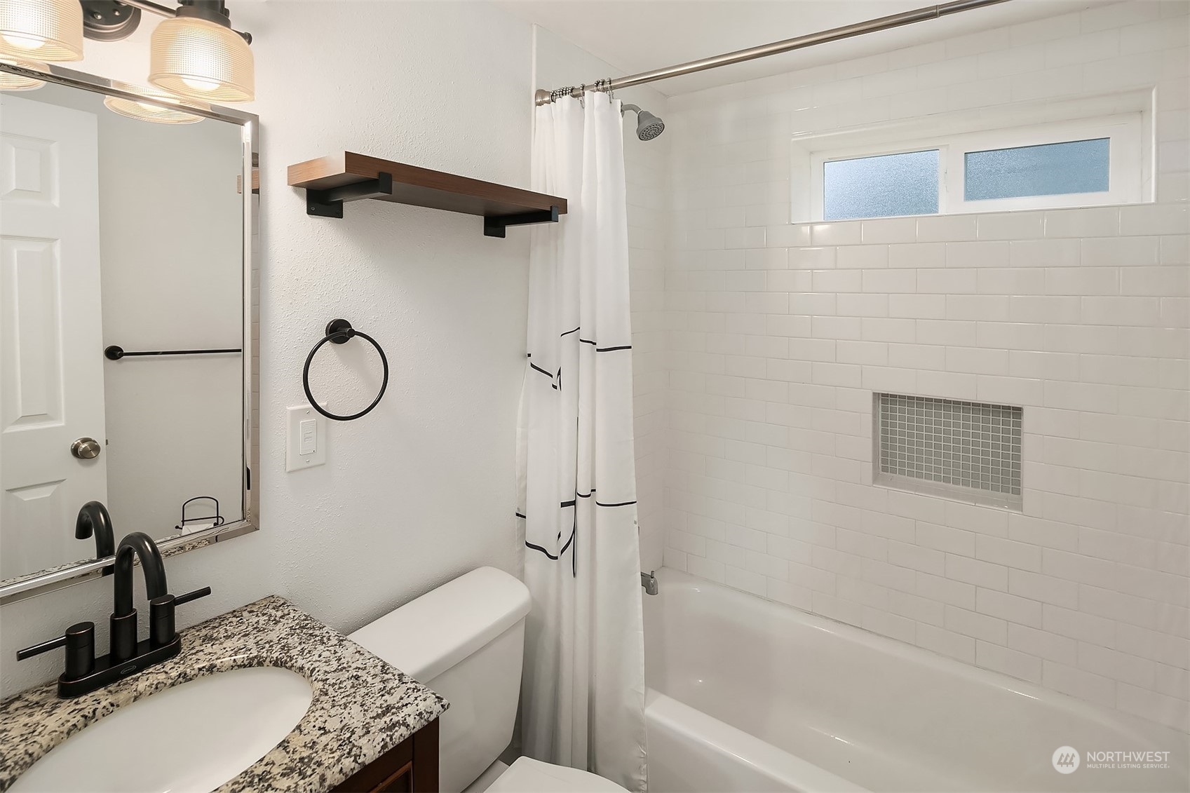 4419 Southeast 4th Place Renton, WA 98059 - Photo 15 of 21 a bathroom with a granite countertop sink a toilet and a mirror