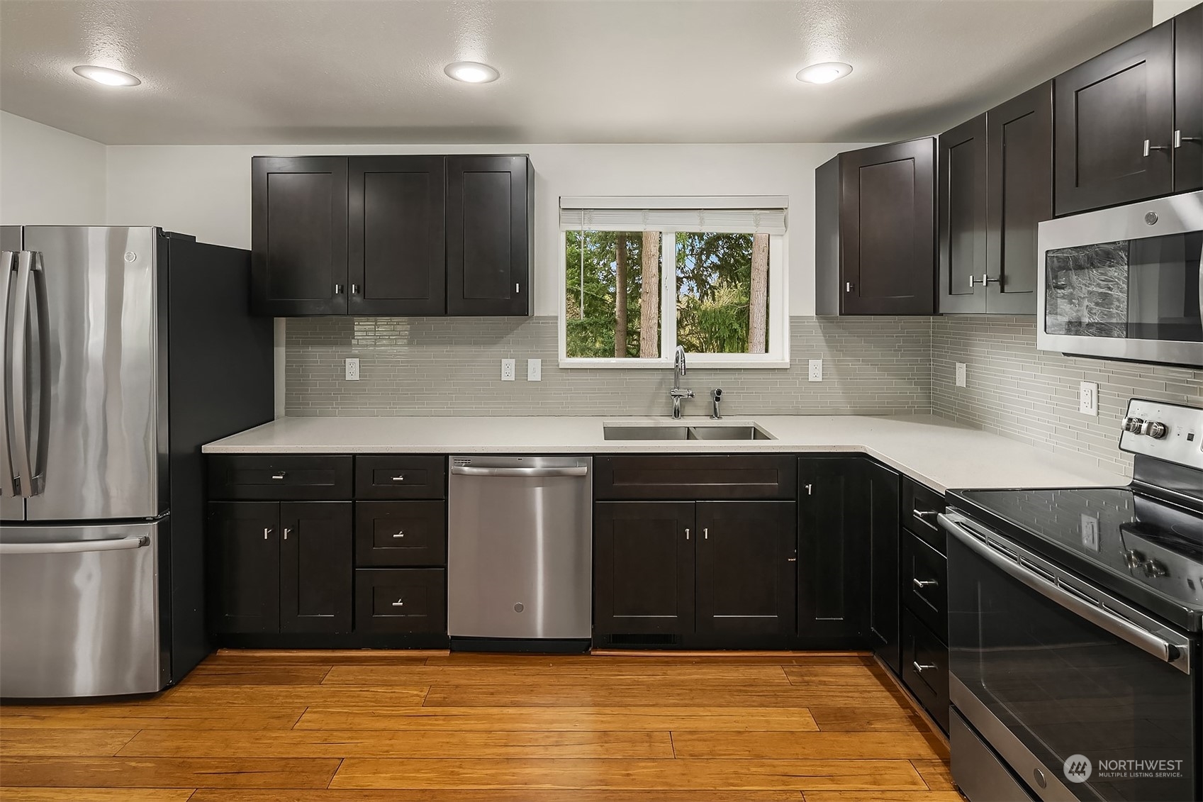 4419 Southeast 4th Place Renton, WA 98059 - Photo 2 of 21 a kitchen with stainless steel appliances granite countertop a sink stove and refrigerator