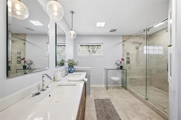 a bathroom with a tub sink and mirror