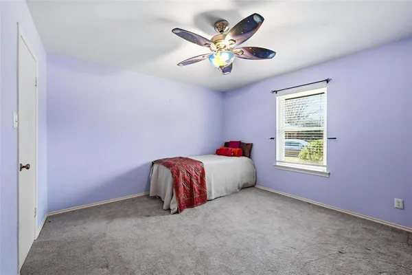 a very nice looking room with a ceiling fan and window