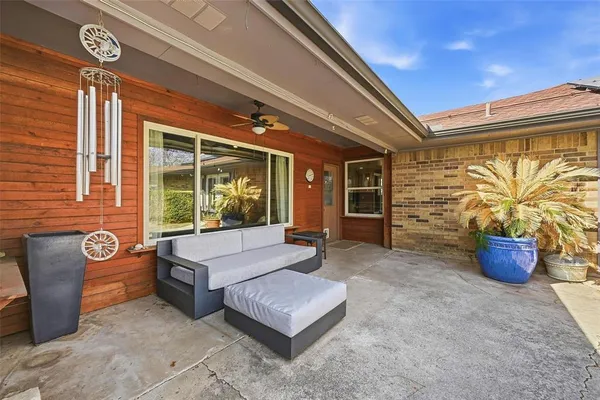 a building outdoor space with patio furniture and potted plants
